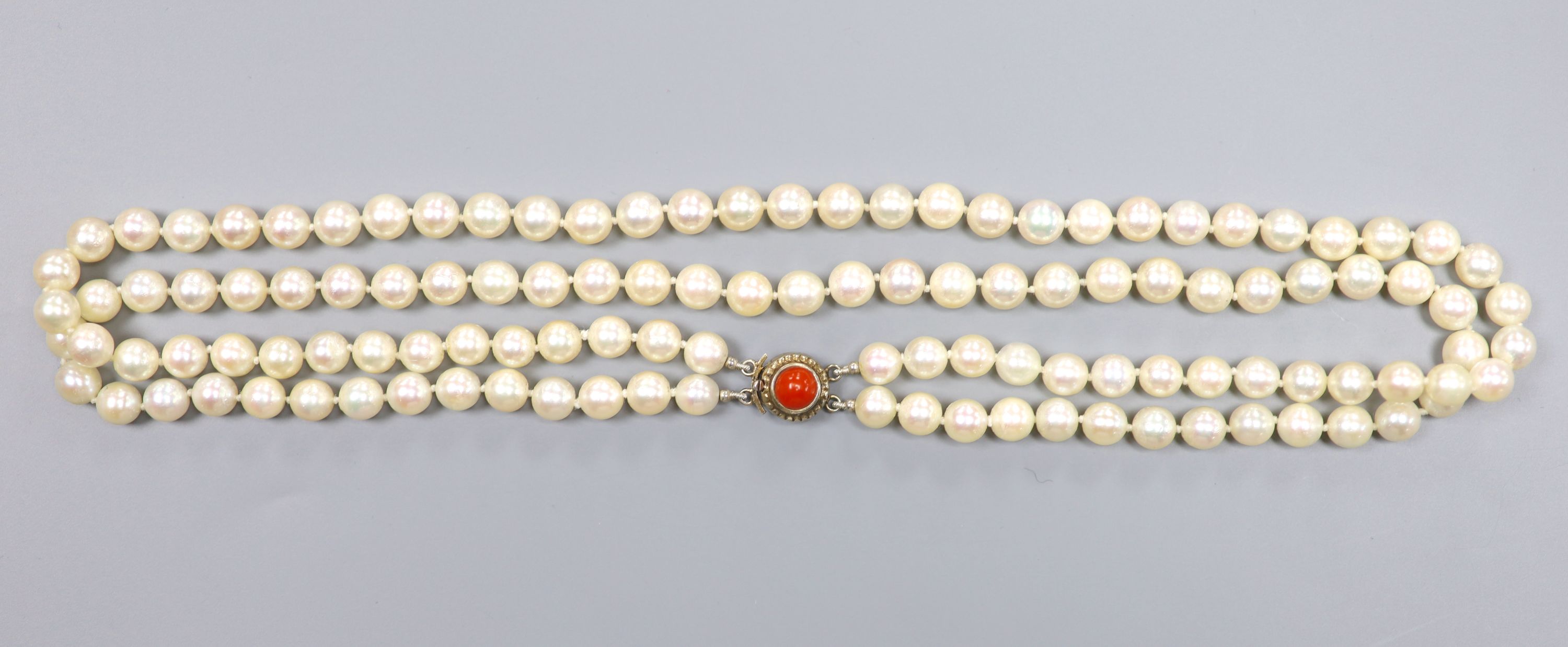 A double strand cultured pearl necklace, with coral bead set 800 white metal clasp, 43cm, gross 51 grams,